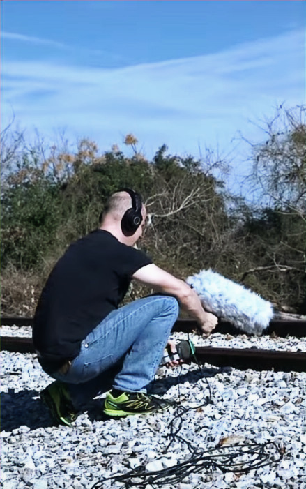 Alex Brandon recording sound in the field