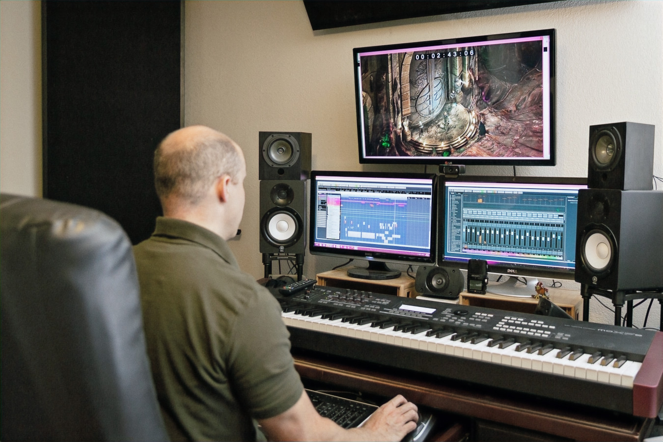 Alex Brandon working at his music workstation